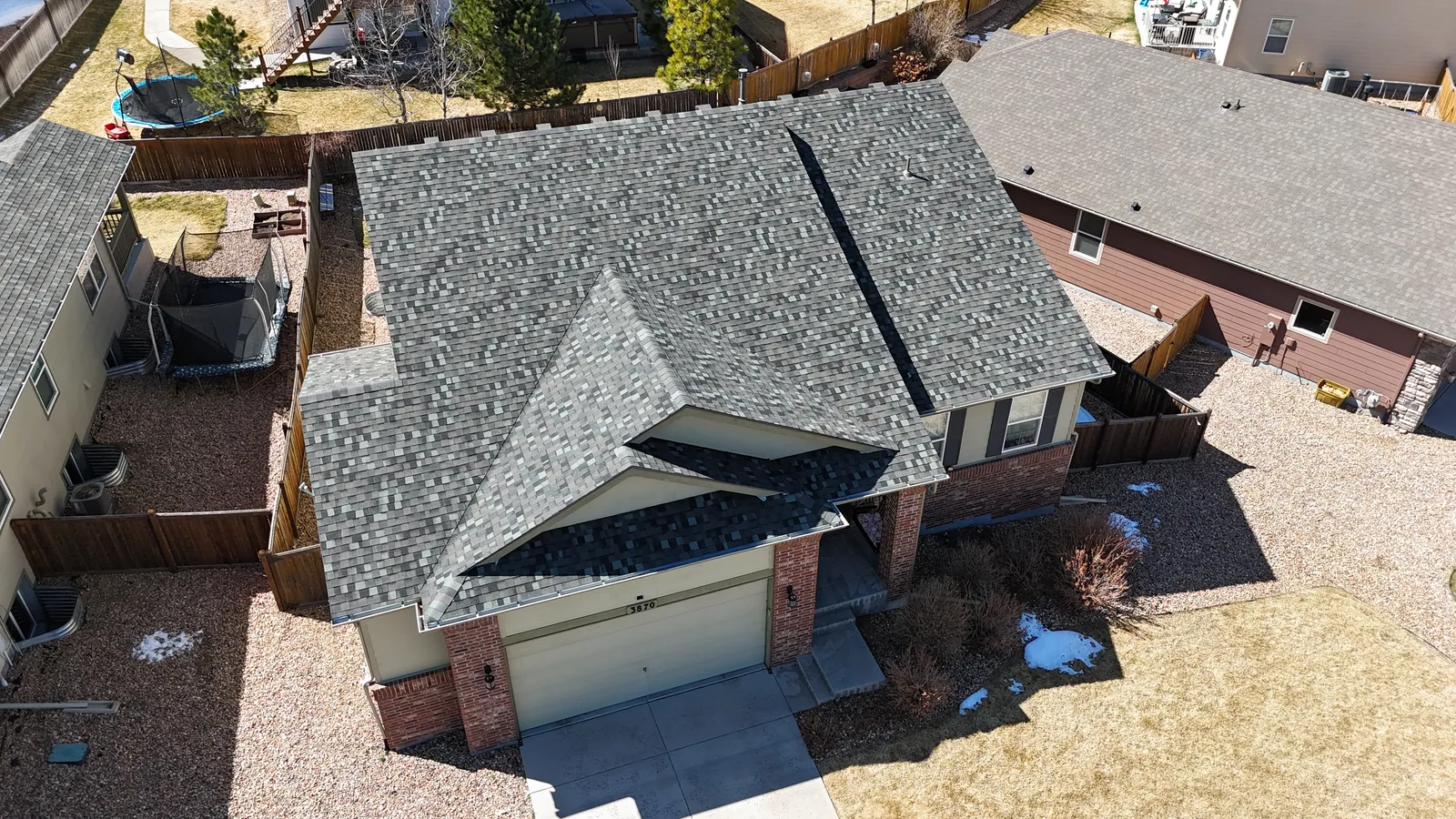 Completed residential shingle roof installed by Battle Axe Roofing